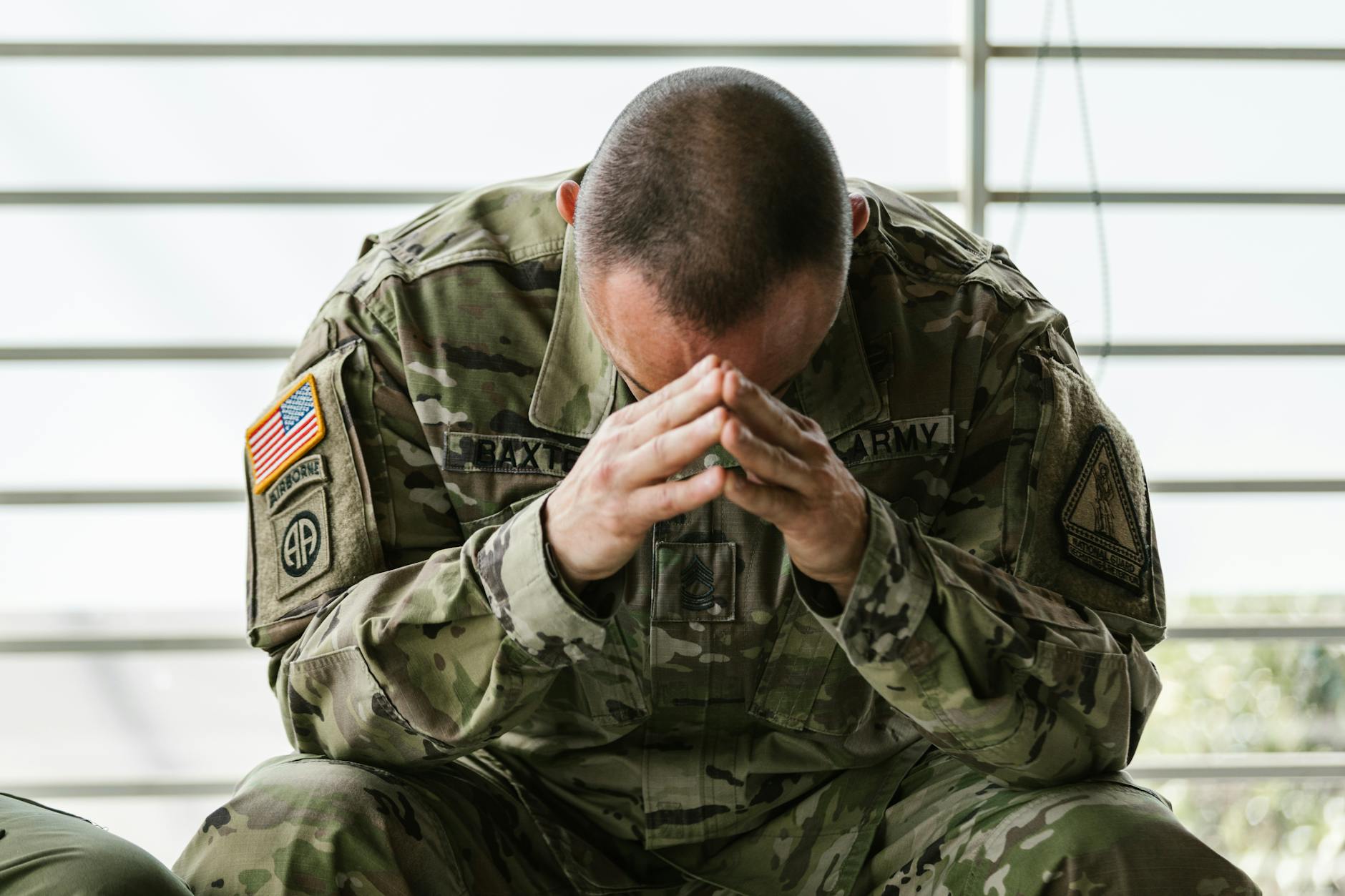 Army veteran trauma head down in combat gear crying
