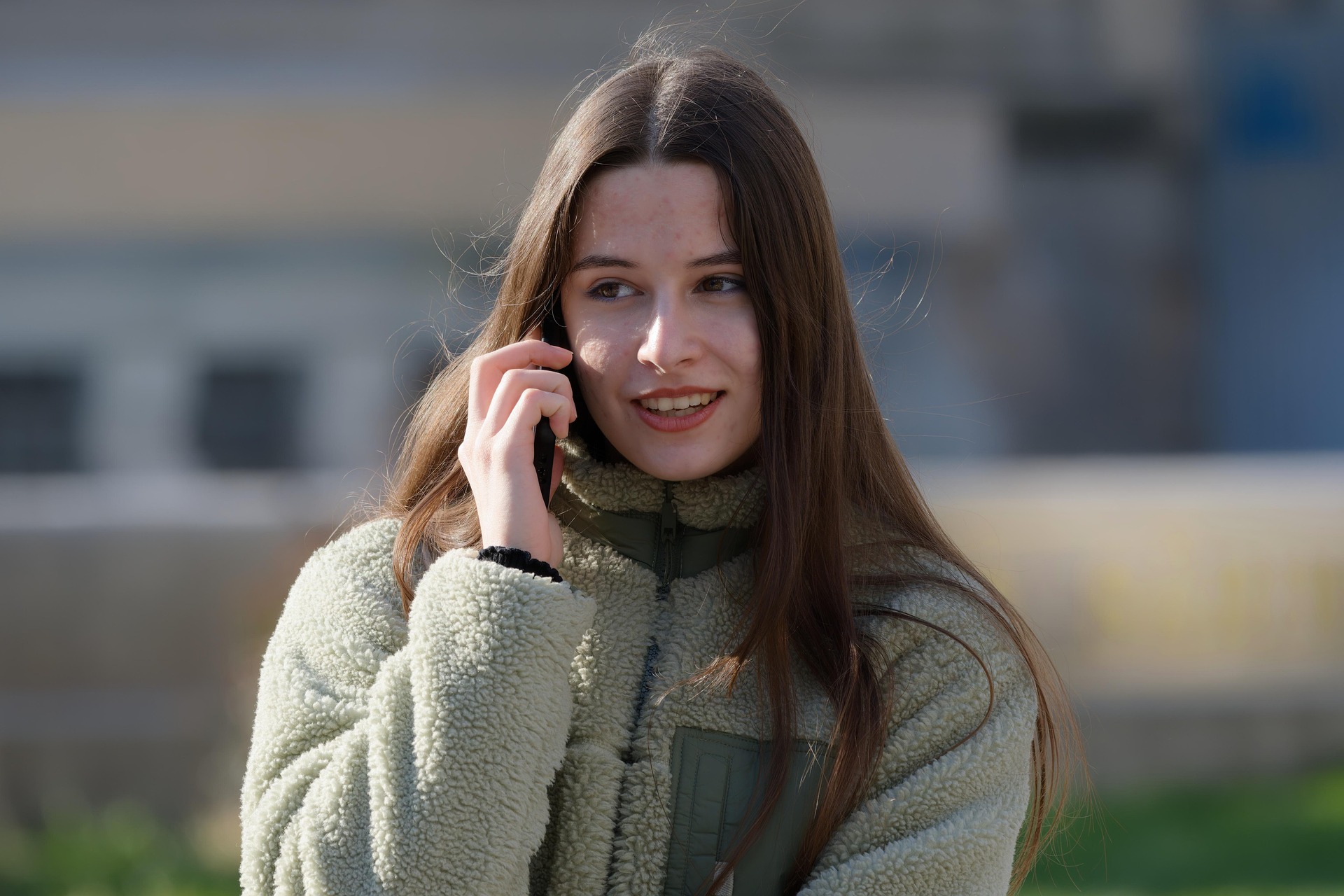 teenager female counselling on the telephone smiling